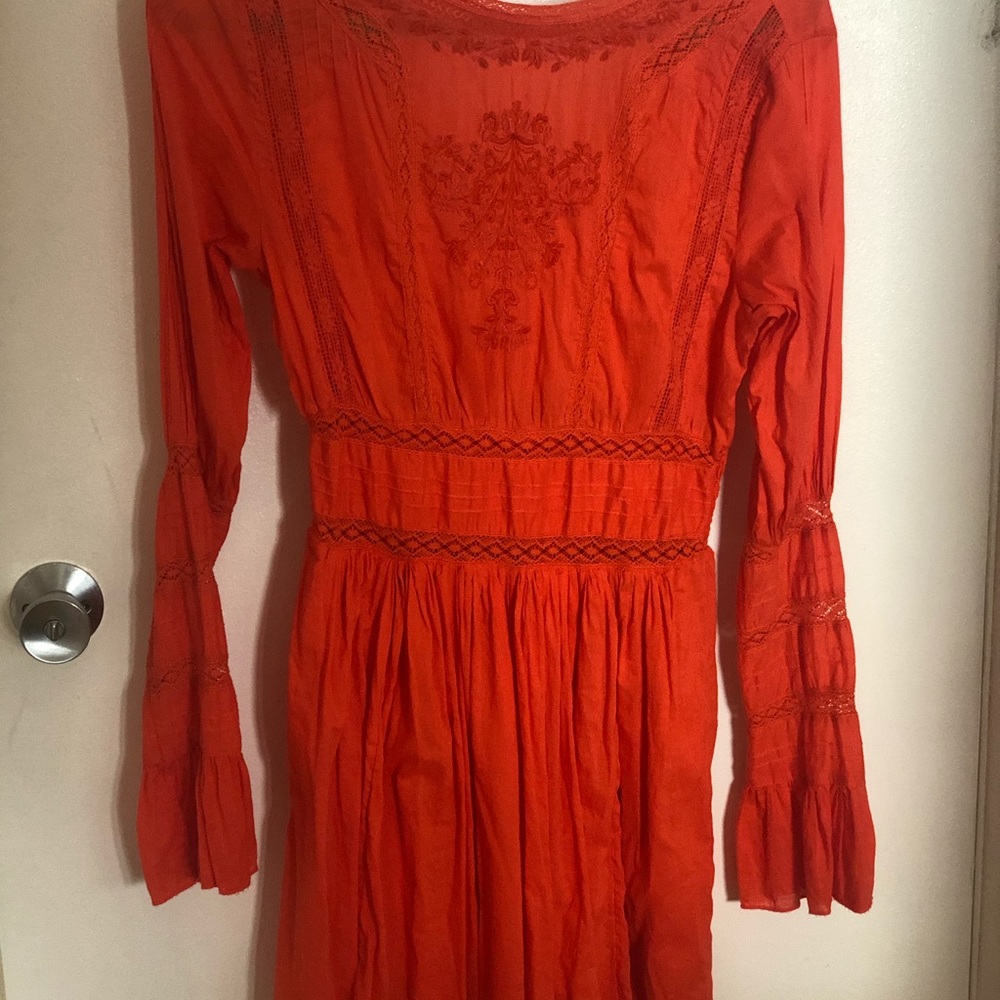 Mini dress. Is reach pastel orange color.